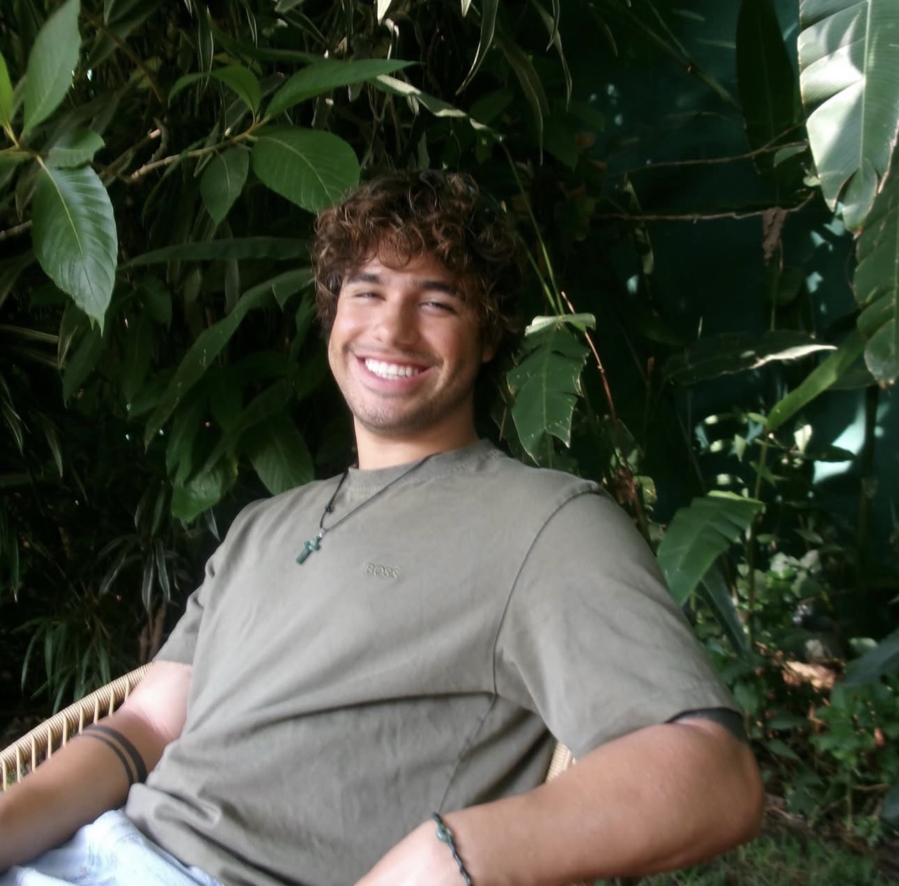 Bani, founder of Vecino Marketing, smiling outdoors surrounded by greenery